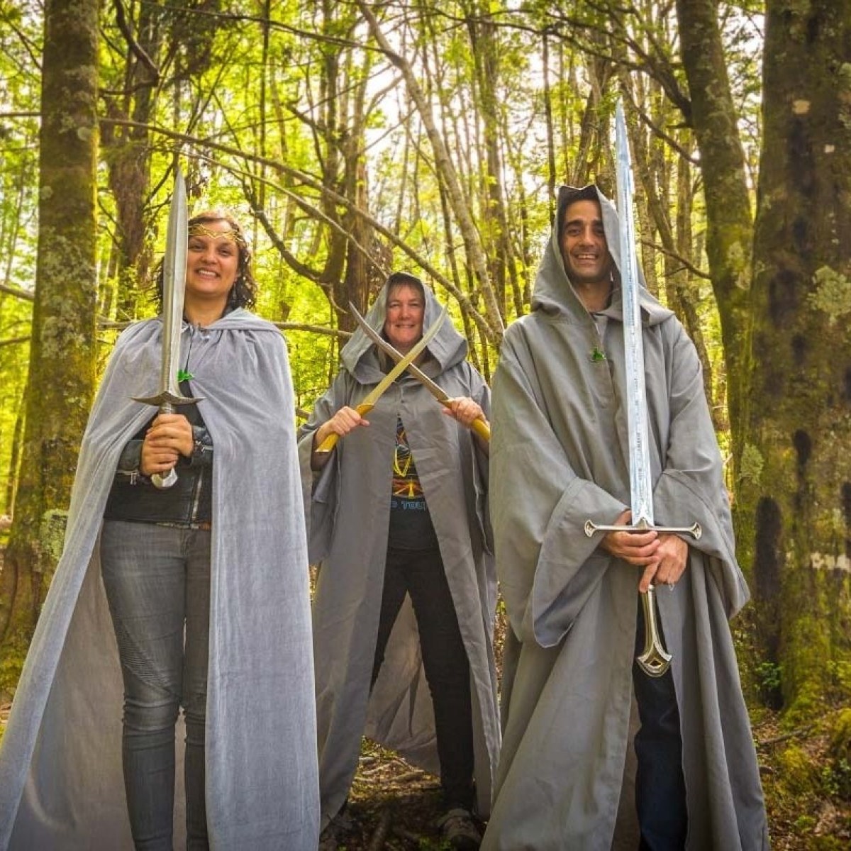 a man and a woman standing next to a forest
