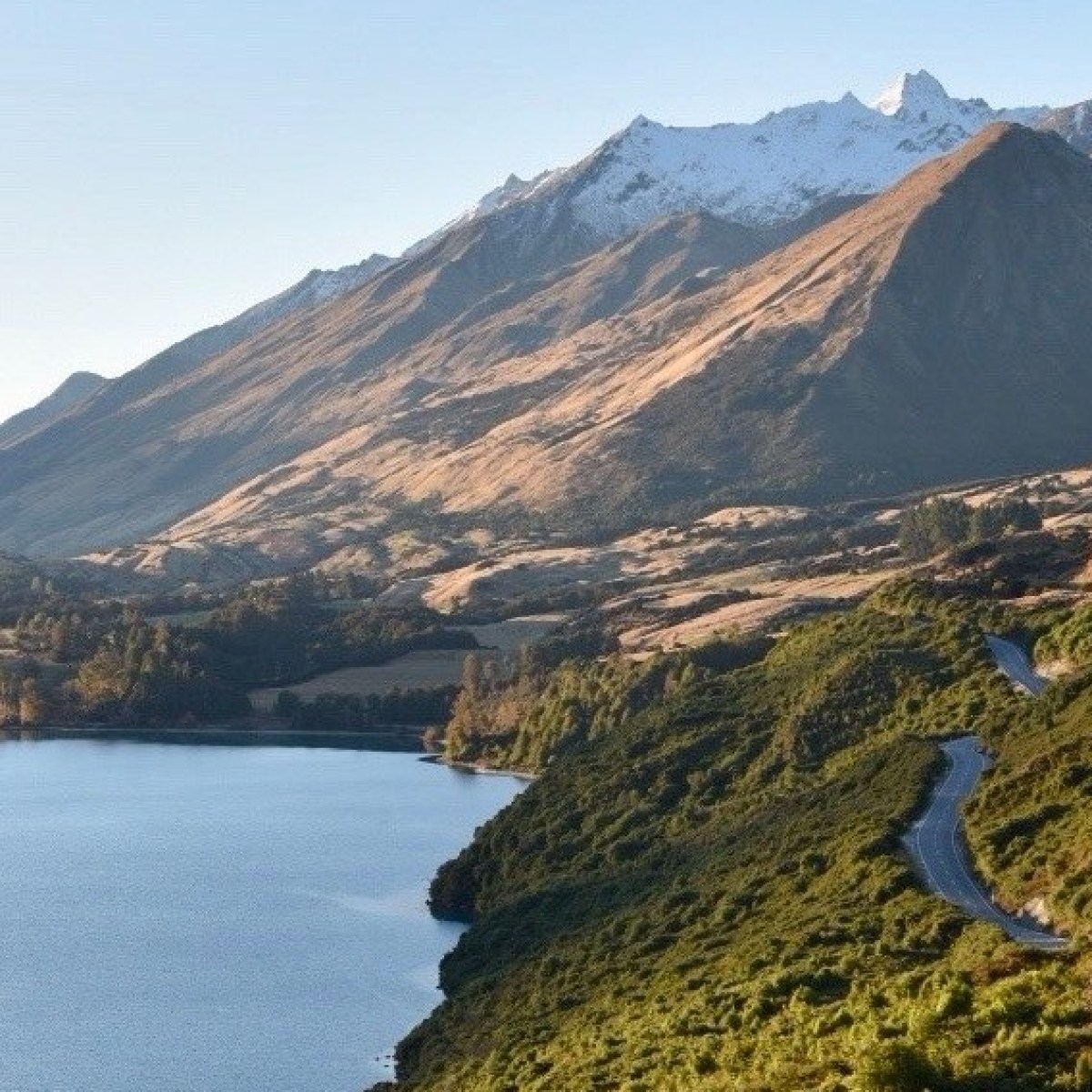 a body of water with a mountain in the background